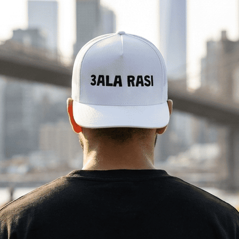 Model wearing 3ala Rasi trucker cap, side angle, Arabic slogan headwear by BOSA