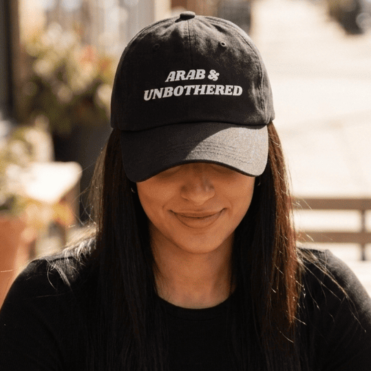 Model wearing Arab & Unbothered dad hat, Arab humor cap by BOSA