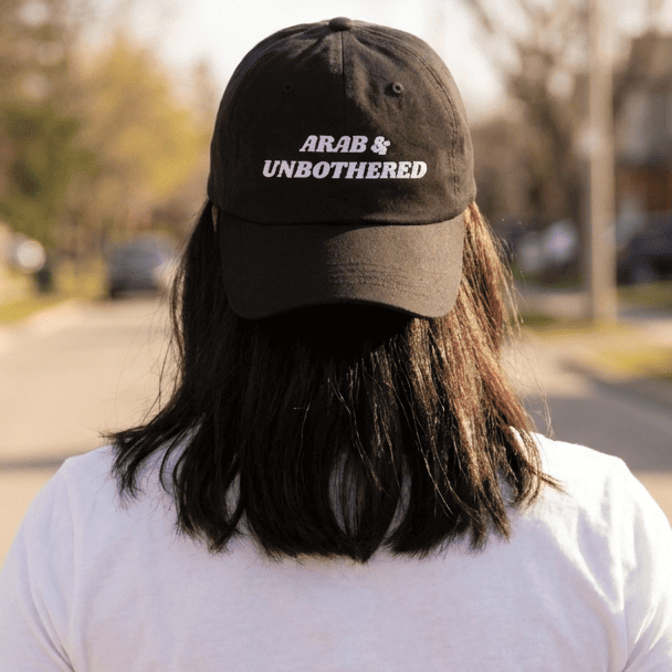 Model wearing Arab & Unbothered dad hat, side angle, Arab humor cap by BOSA