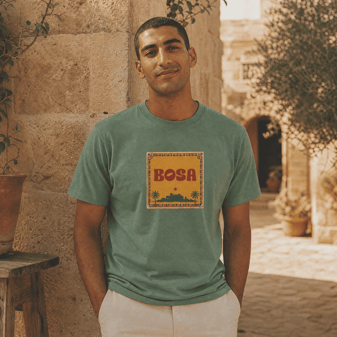 Model wearing BOSA logo unisex heavyweight t-shirt in green, Arab diaspora streetwear by BOSA