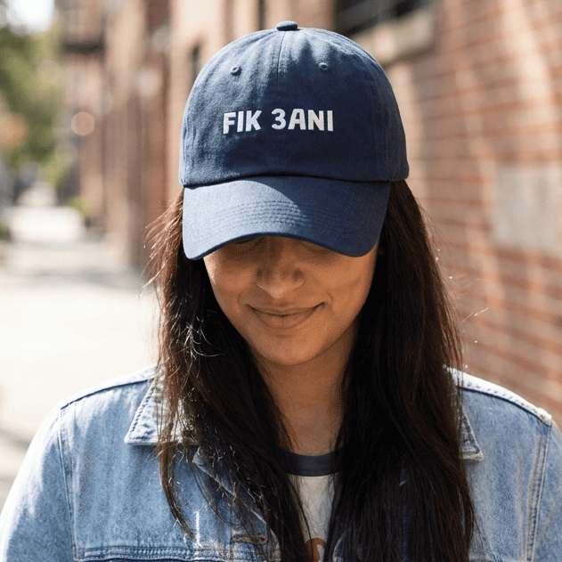 Model wearing Fik 3ani dad hat, Arabic slogan cap by BOSA