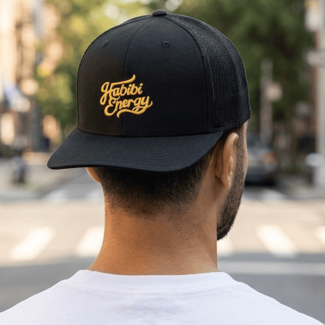 Model wearing Habibi Energy trucker cap, Arabic slogan headwear by BOSA
