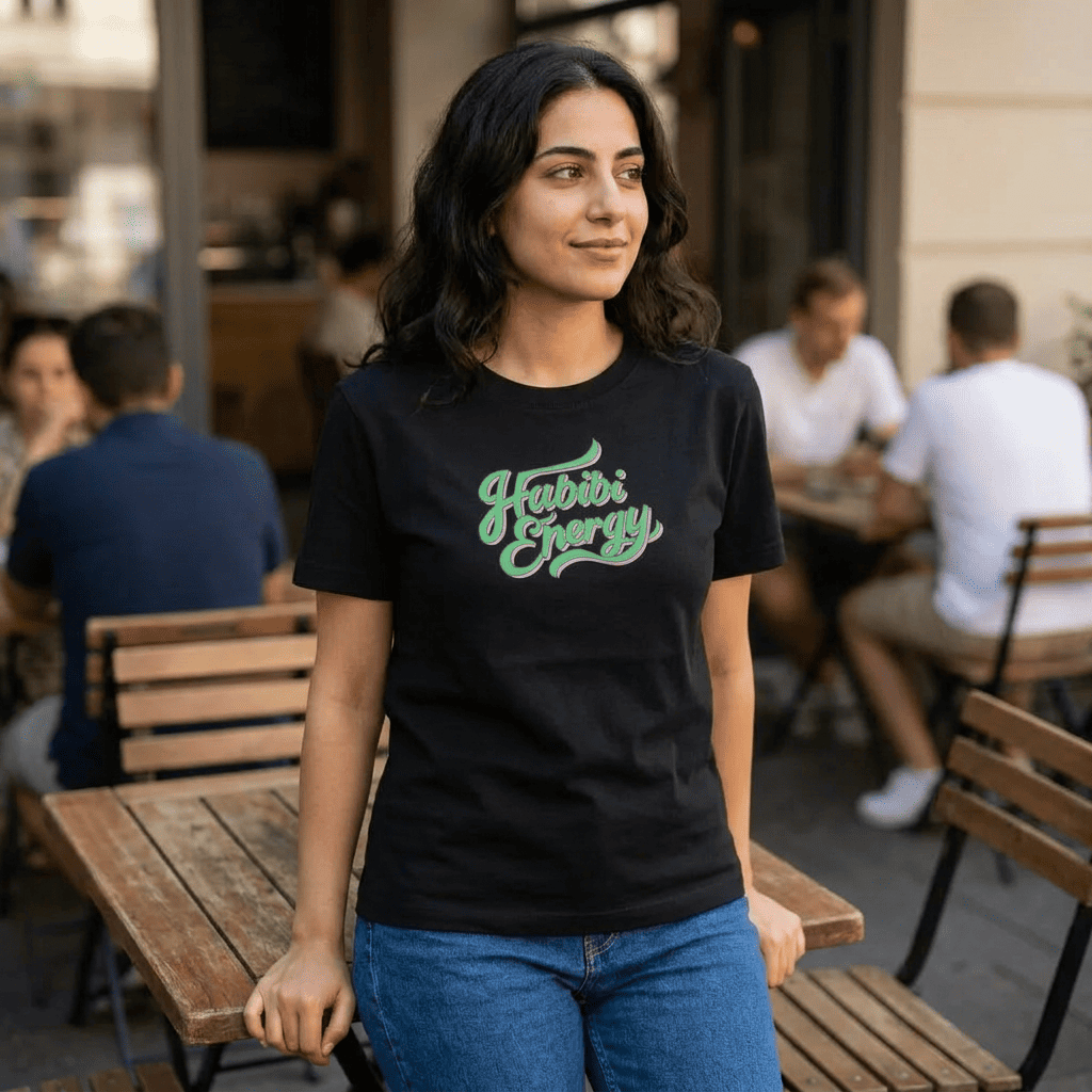 Woman wearing Habibi Energy organic ribbed neck t-shirt, side angle, Arabic slogan streetwear by BOSA
