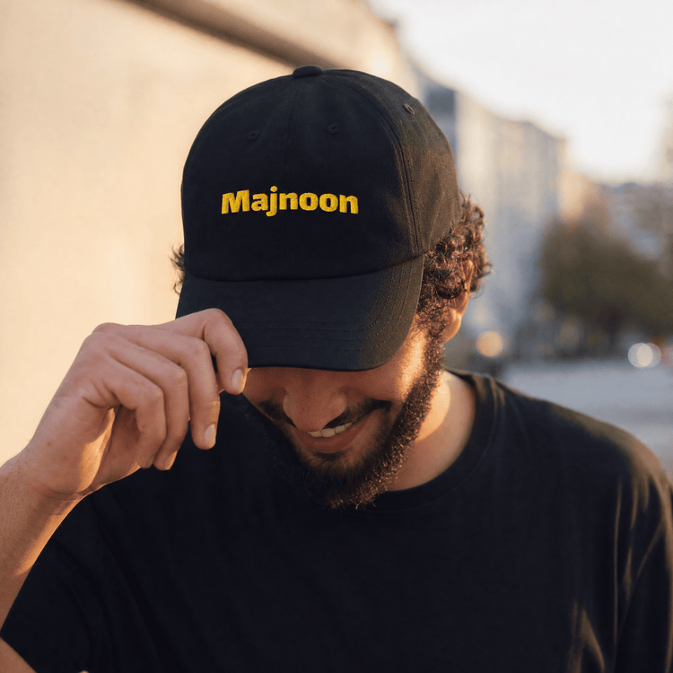 Model wearing Majnoon dad hat, Arabic slogan cap by BOSA