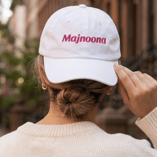Model wearing Majnoona dad hat, Arabic slogan cap by BOSA