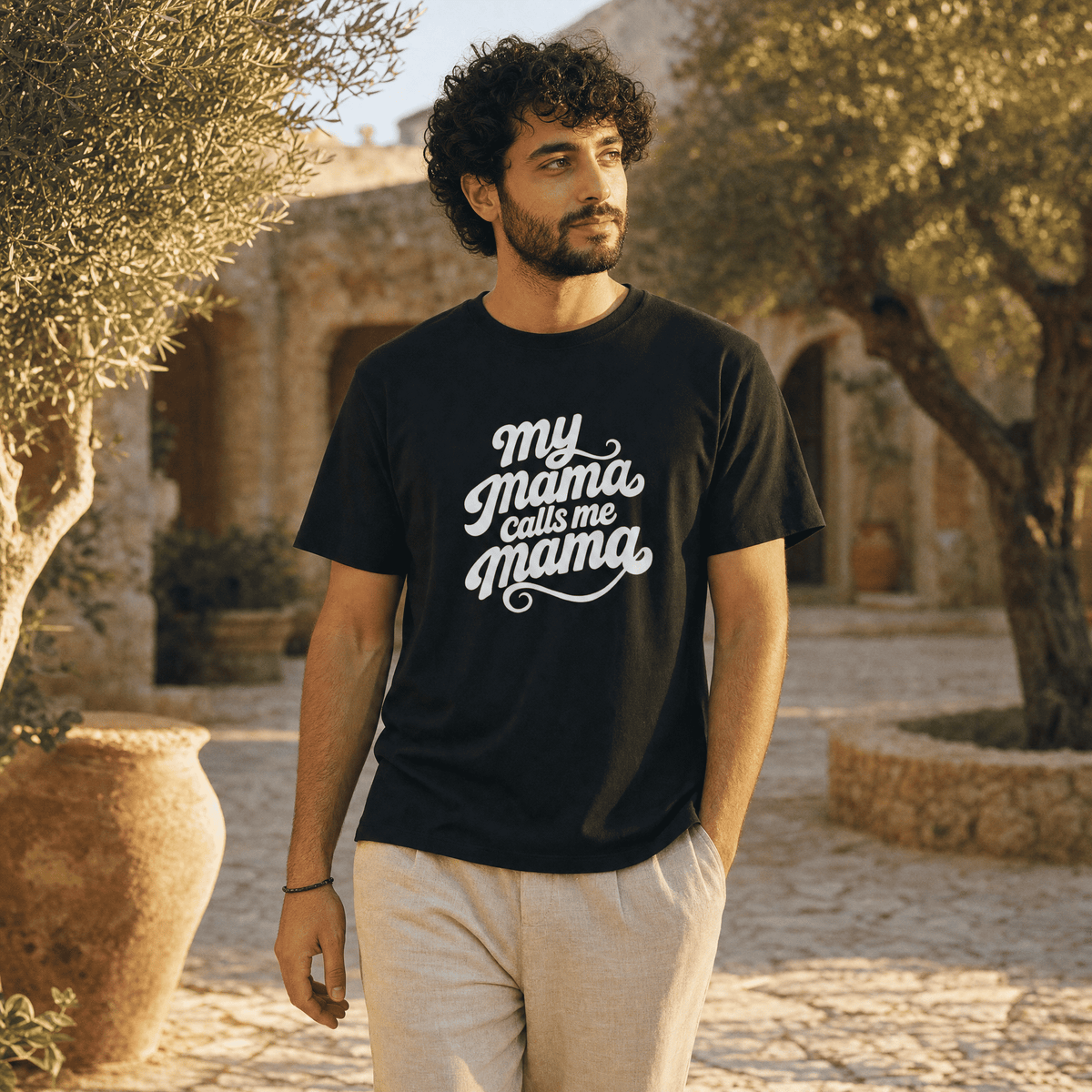 Model wearing My Mama Calls Me Mama unisex cotton t-shirt, side angle, Arab mom slogan apparel by BOSA