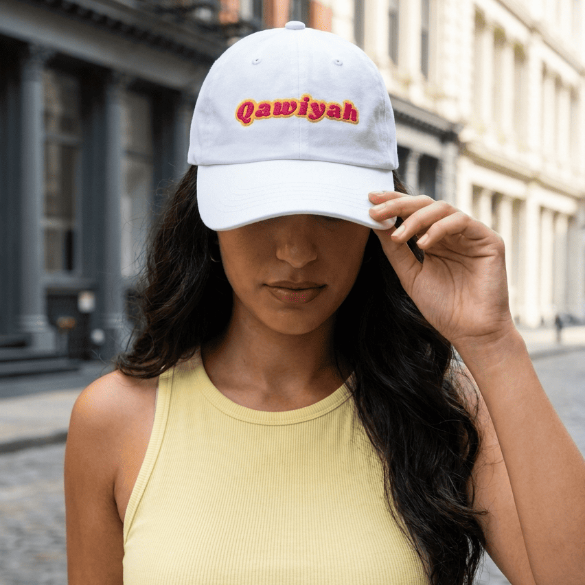 Model wearing Qawiyah dad hat, Arabic strong woman slogan cap by BOSA