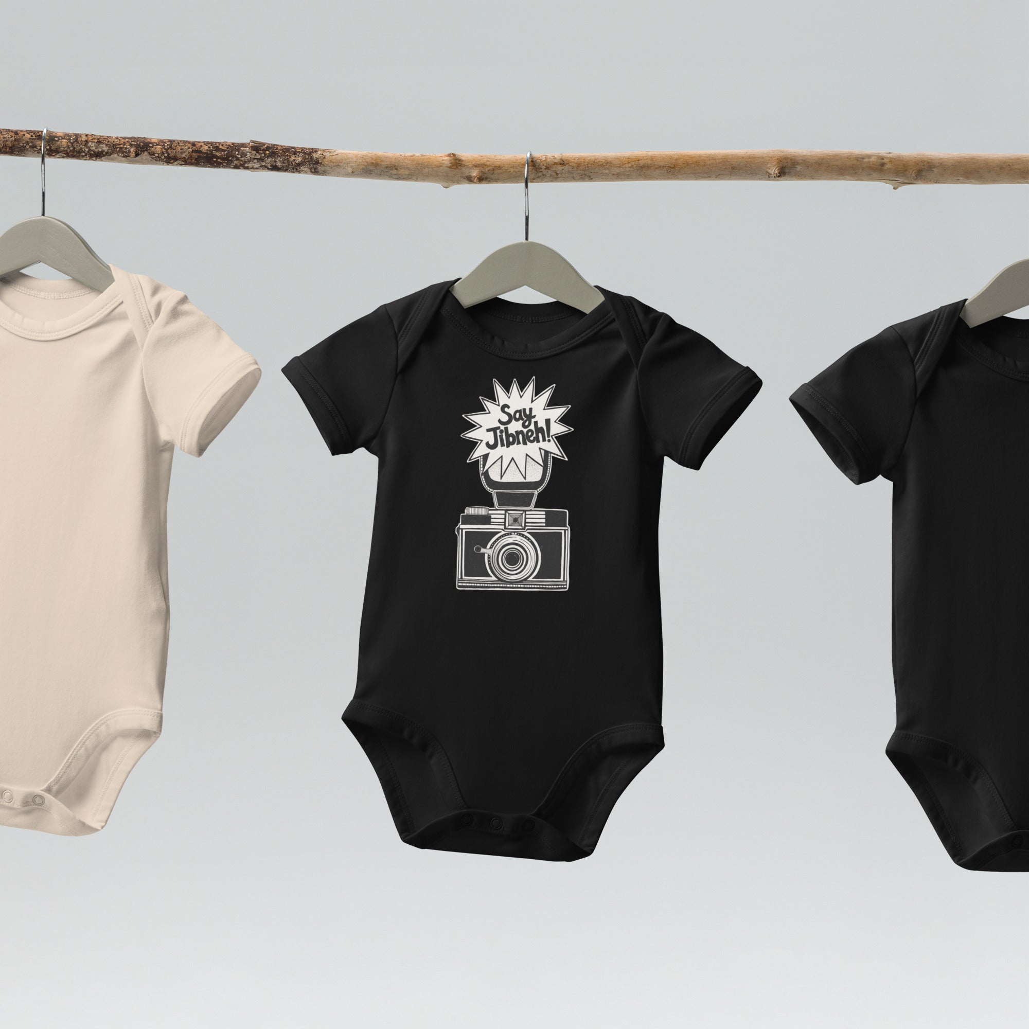 Say Jibneh organic cotton baby bodysuit in black, front view, Arab food humor baby clothing by BOSA