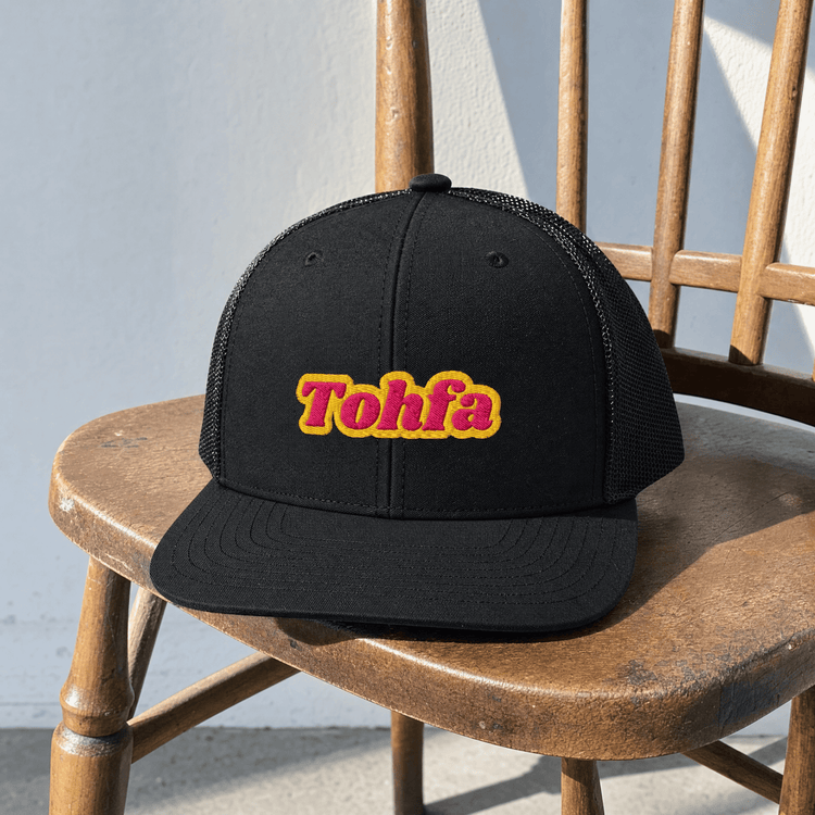Model wearing Tohfa trucker cap, Arabic slogan headwear by BOSA