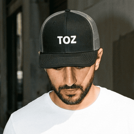 Model wearing Toz trucker cap, Arabic slogan headwear by BOSA